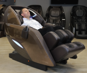 Picture of a Massage Chair Store Review Team member reclining in a bronze Kyota M989 Yutaka massage chair.