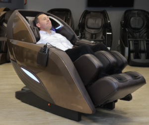 Picture-of-a-Massage-Chair-Store-Review-Team-member-reclining-in-a-bronze-Kyota-M989-Yutaka-massage-chair. 
