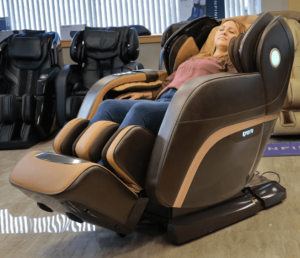 A member of the Massage Chair Store Review Team reclines in a brown Kyota M888 Kokoro massage chair.