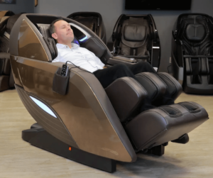 One of the members of the Massage Chair Store Team reclines in a bronze Kyota M898 Yutaka 4D massage chair.