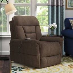 Recliner with brown polyester blend upholstery in upright position in front of large windows.