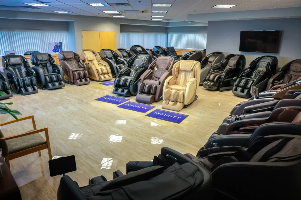 Different massage chairs in colors like black, brown and tan are displayed in the Massage Chair Store show room.